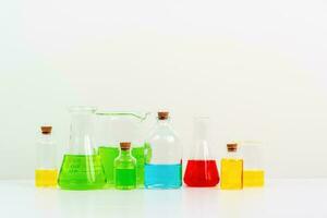 some test tube on the white table with beakers, flasks, and test tubes filled with colorful liquids photo