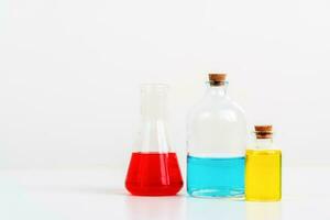 some test tube on the white table with beakers, flasks, and test tubes filled with colorful liquids photo