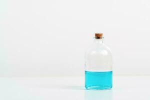 some test tube on the white table with beakers, flasks, and test tubes filled with colorful liquids photo