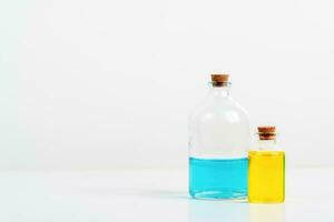 some test tube on the white table with beakers, flasks, and test tubes filled with colorful liquids photo