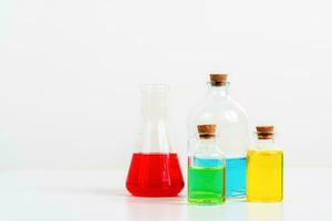 some test tube on the white table with beakers, flasks, and test tubes filled with colorful liquids photo