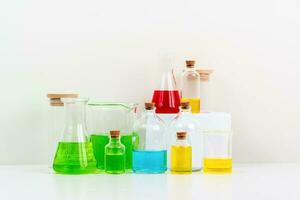 some test tube on the white table with beakers, flasks, and test tubes filled with colorful liquids photo