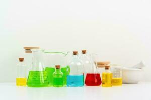 some test tube on the white table with beakers, flasks, and test tubes filled with colorful liquids photo