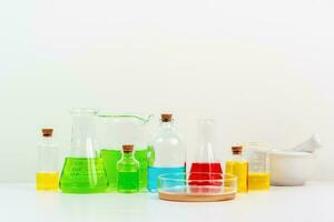 some test tube on the white table with beakers, flasks, and test tubes filled with colorful liquids photo