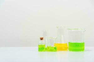 some test tube on the white table  with beakers, flasks, and test tubes filled with colorful liquids photo