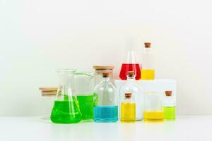 some test tube on the white table with beakers, flasks, and test tubes filled with colorful liquids photo