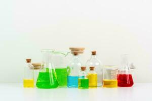 some test tube on the white table with beakers, flasks, and test tubes filled with colorful liquids photo