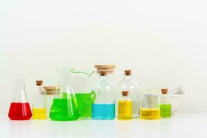 some test tube on the white table with beakers, flasks, and test tubes filled with colorful liquids photo