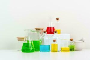 some test tube on the white table with beakers, flasks, and test tubes filled with colorful liquids photo