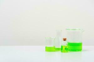 some test tube on the white table  with beakers, flasks, and test tubes filled with colorful liquids photo