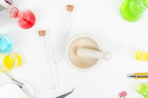 Top view science lab chemistry flask with beakers, flasks, and test tubes filled with colorful liquids photo