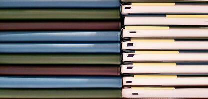 Close up pattern and line of colorful spine or saddle book are sorting and stacking for background. Art group of object, Education and Library concept photo