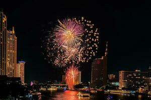 fireworks on the river in the dark sky photo