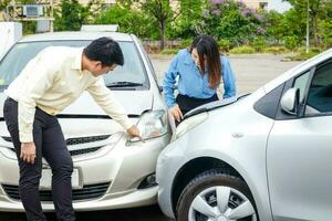 The concept of car insurance. car accident on road Men and women look at damaged cars to file insurance claims. photo