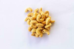 Many Roasted salted cashew nuts  isolated on a white background photo