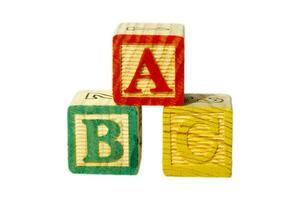 Three wooden blocks for children on white with letters A, B and C. photo