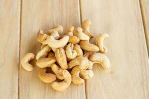 Many Roasted salted cashew nuts  on wooden background photo