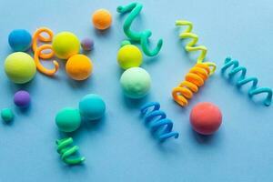 Colorful abstract figures made of plasticine, spirals and balls of different sizes. Funny illustration for the background of children's holidays photo