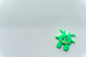 Plasticine 3D UFO, spaceship sculpture, cute green alien on white background photo