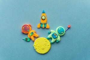 Astronauts On The Moon. Astronaut Is Made Out Of Play Clay. Spaceship, moon and two cute cosmonauts photo