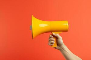 Megaphone in hands on a orange background photo