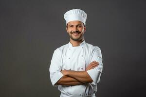 contento joven cocinero posando en uniforme foto