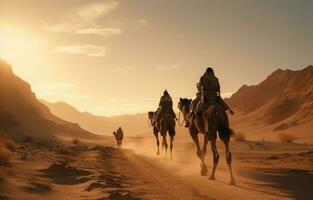 People riding camels on a sand dune in the desert photo