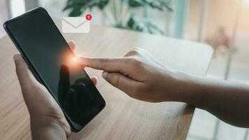 Human hand touching email on virtual screen. New email notification concept for business email communication and digital marketing. The inbox receives electronic message notifications. photo