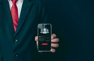 Login. A businessman's finger is holding a phone. Represents protection against external hacks. Concept of protection against code, viruses, firmware, and malware. photo