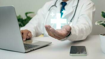 Doctor holding and plus sign at hospital office. Medical health care and medical services. photo