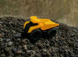 A dump truck on a pile of stones and sand, after some edits. photo