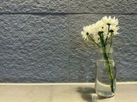 Beautiful white flower decoration with gray textured walls photo