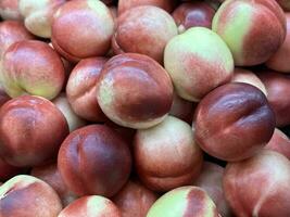 Fresh red peaches stacked fruit photo