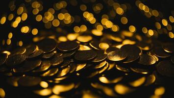 Shiny gold coin with blurred dark background photo