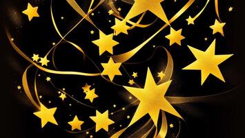 Glittering gold powder stars with ribbons, dark background photo