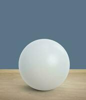 white sphere with shadow on Colored walls on wooden floor, interior decoration photo