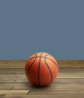 A basketball with Colored walls on wooden floor photo