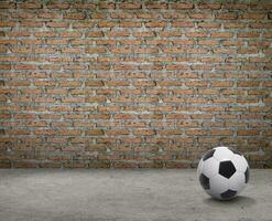 soccer ball in room with brick wall and cement floor photo