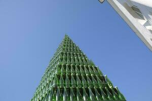 Christmas tree of bottles of champagne. Creative from bottles. Empty bottles of champagne photo