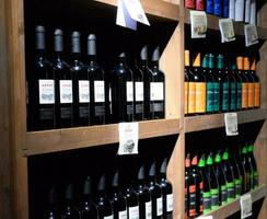 Shelves with wine and champagne in the store winery. Counter at the winery. photo