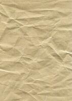 Brown wrinkled paper texture photo background. Old crumpled grunge paper surface backdrop.