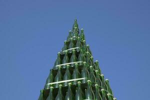 Christmas tree of bottles of champagne. Creative from bottles. Empty bottles of champagne photo