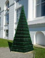 Christmas tree of bottles of champagne. Creative from bottles. Empty bottles of champagne photo