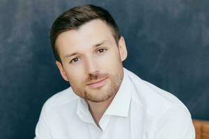 Handsome male worker, white shirt, dark background. Ready for date with girlfriend. photo