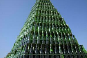 Christmas tree of bottles of champagne. Creative from bottles. Empty bottles of champagne photo