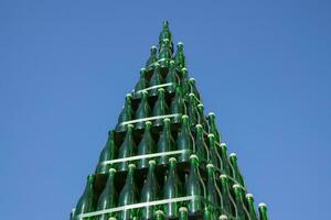 Christmas tree of bottles of champagne. Creative from bottles. Empty bottles of champagne photo