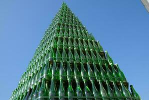 Christmas tree of bottles of champagne. Creative from bottles. Empty bottles of champagne photo