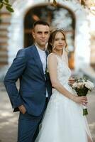 newlyweds walk in the city near old buildings photo