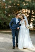 newlyweds walk in the city near old buildings photo