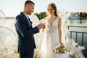 wedding ceremony of the newlyweds on the pier photo